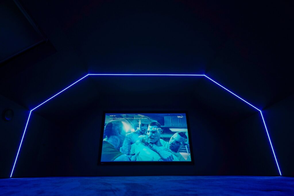 Home cinema installation. Dark room with ambient blue light beams.